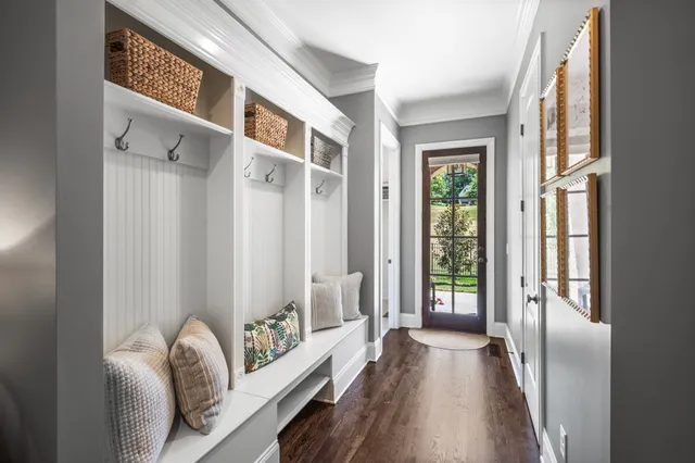 a living room with furniture potted plant and a large window