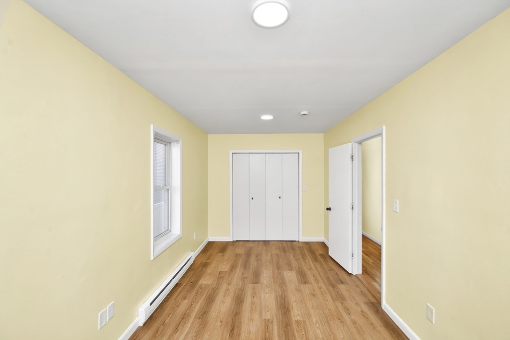 11 Greendale Road, Unit 2 Boston, MA 02126 - Photo 12 of 25 a view of a room with wooden floor and brick walls