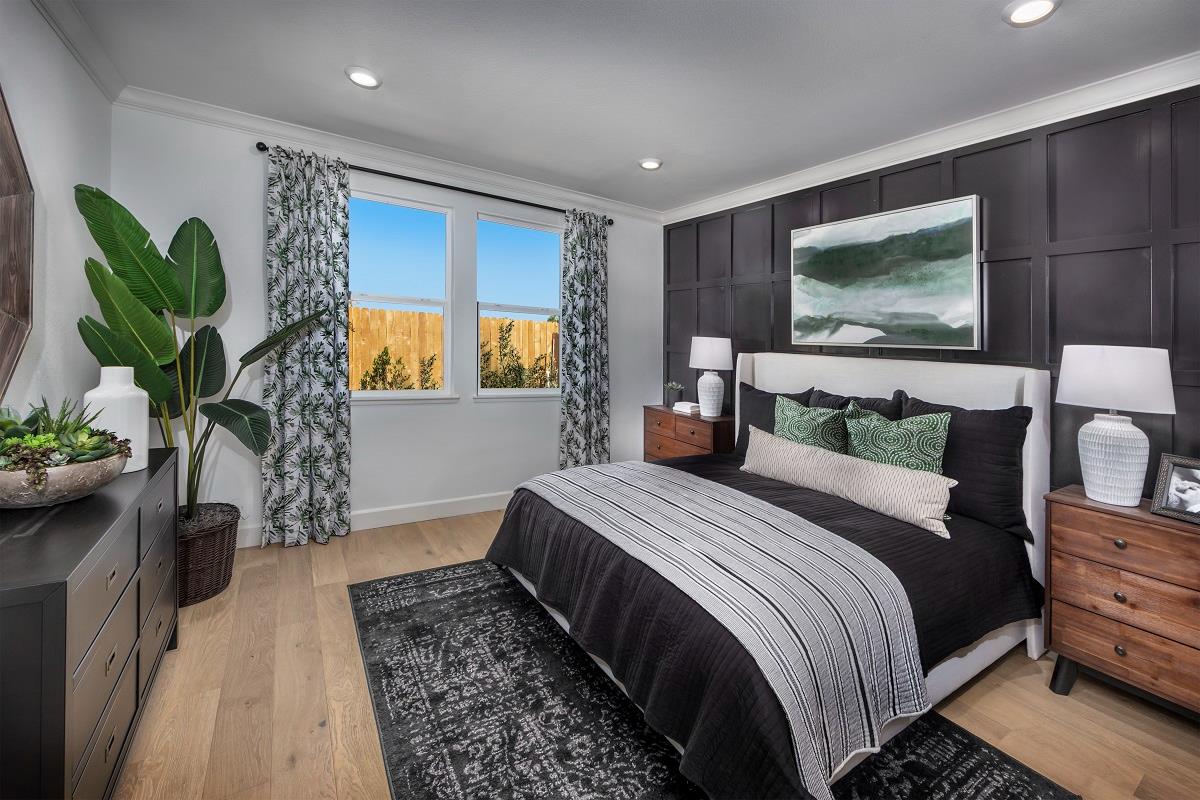 3235 Lourdes Avenue Clovis, CA 93619 - Photo 10 of 13 a bedroom with a bed a dresser with wooden floor