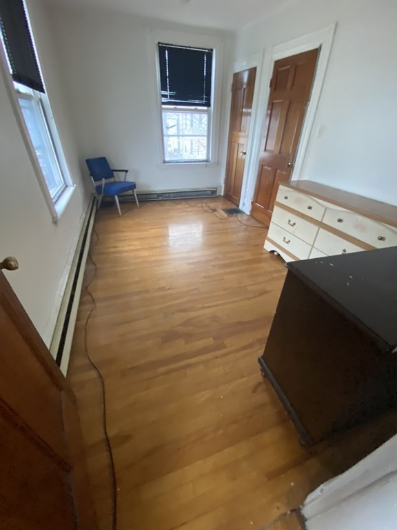 29 East Cottage Street Boston, MA 02125 - Photo 11 of 13 a view of a livingroom with wooden floor and a window