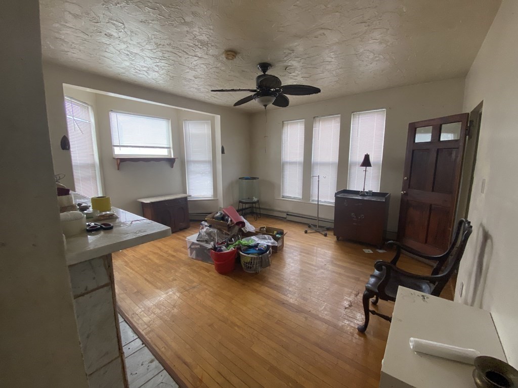 29 East Cottage Street Boston, MA 02125 - Photo 4 of 13 a room with furniture and wooden floor