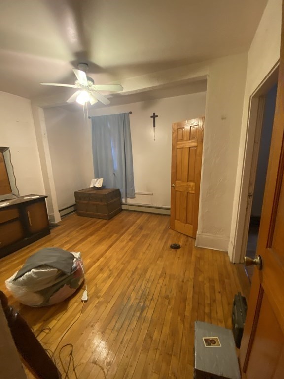 29 East Cottage Street Boston, MA 02125 - Photo 6 of 13 a bedroom with a bed and a mirror