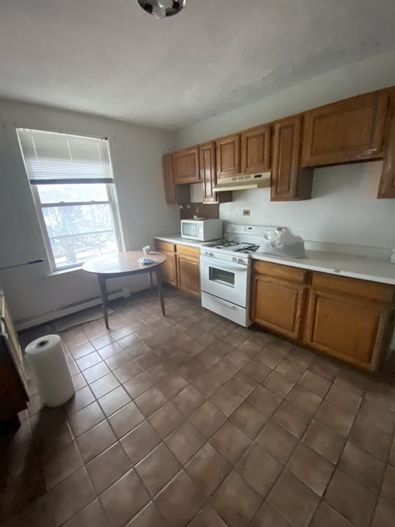 29 East Cottage Street Boston, MA 02125 - Photo 7 of 13 a kitchen with stainless steel appliances granite countertop a sink and cabinets
