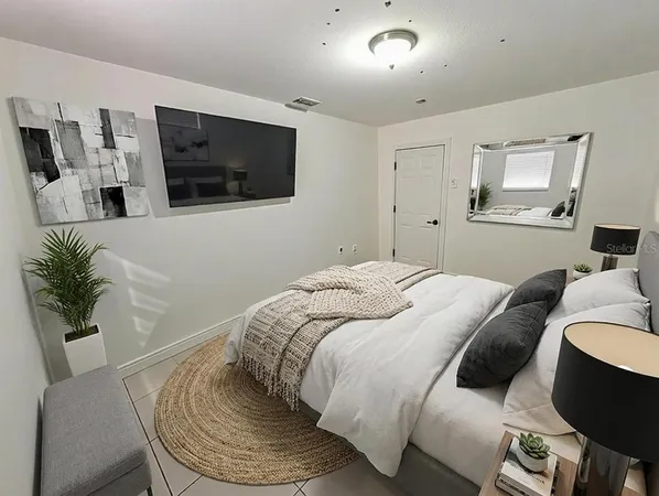 a bedroom with a bed and a chandelier