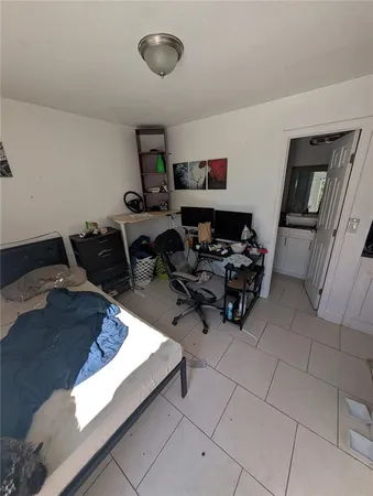 a bedroom with furniture and a window