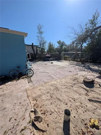 a backyard of a house with table and chairs