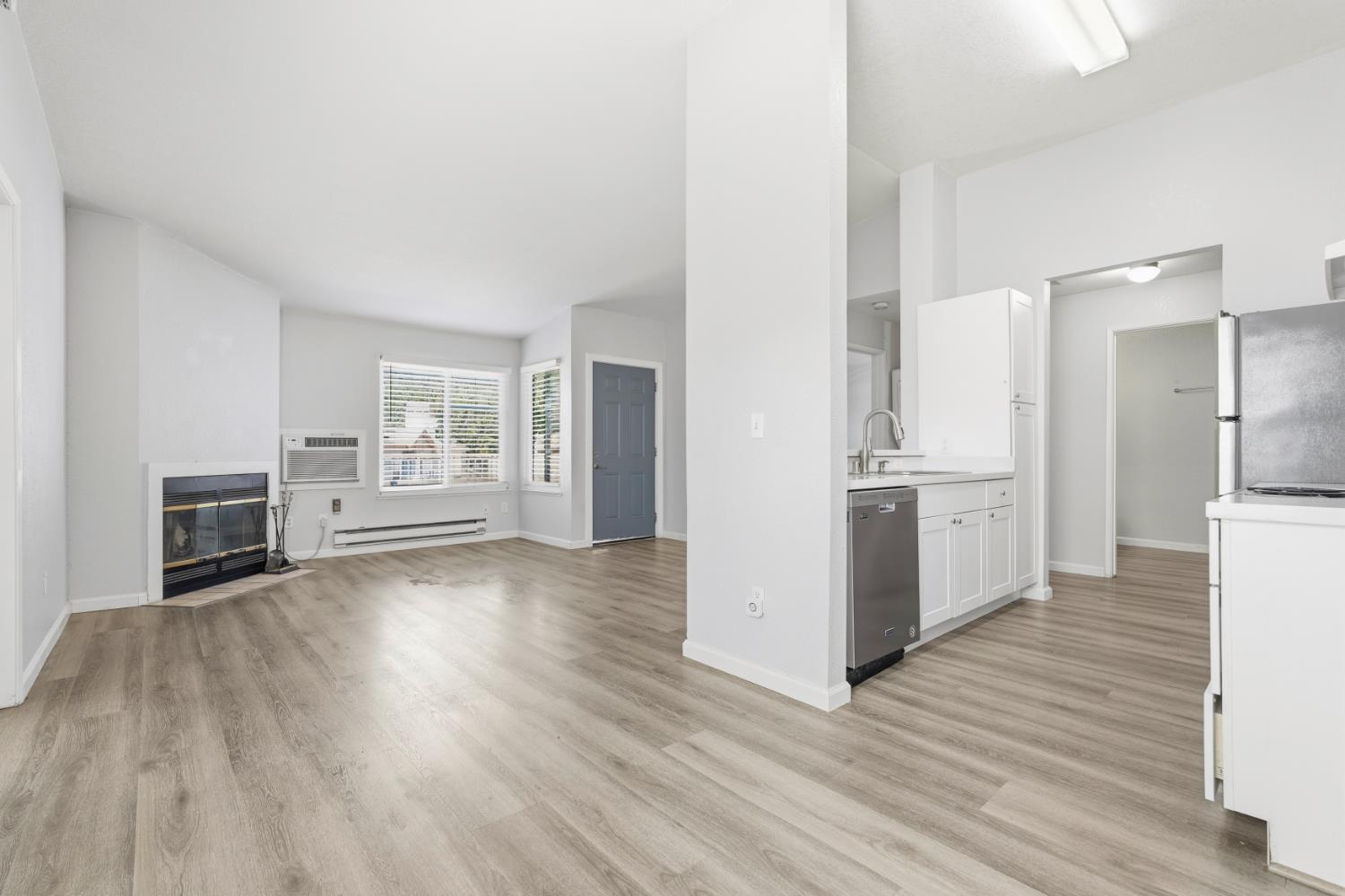 a view of a kitchen with wooden floor and a kitchen