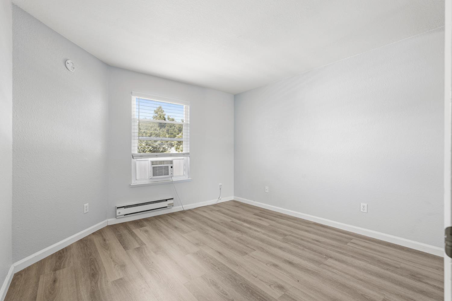 3 Lancaster Circle, Unit 209 Bay Point, CA 94565 - Photo 15 of 30 an empty room with wooden floor and windows