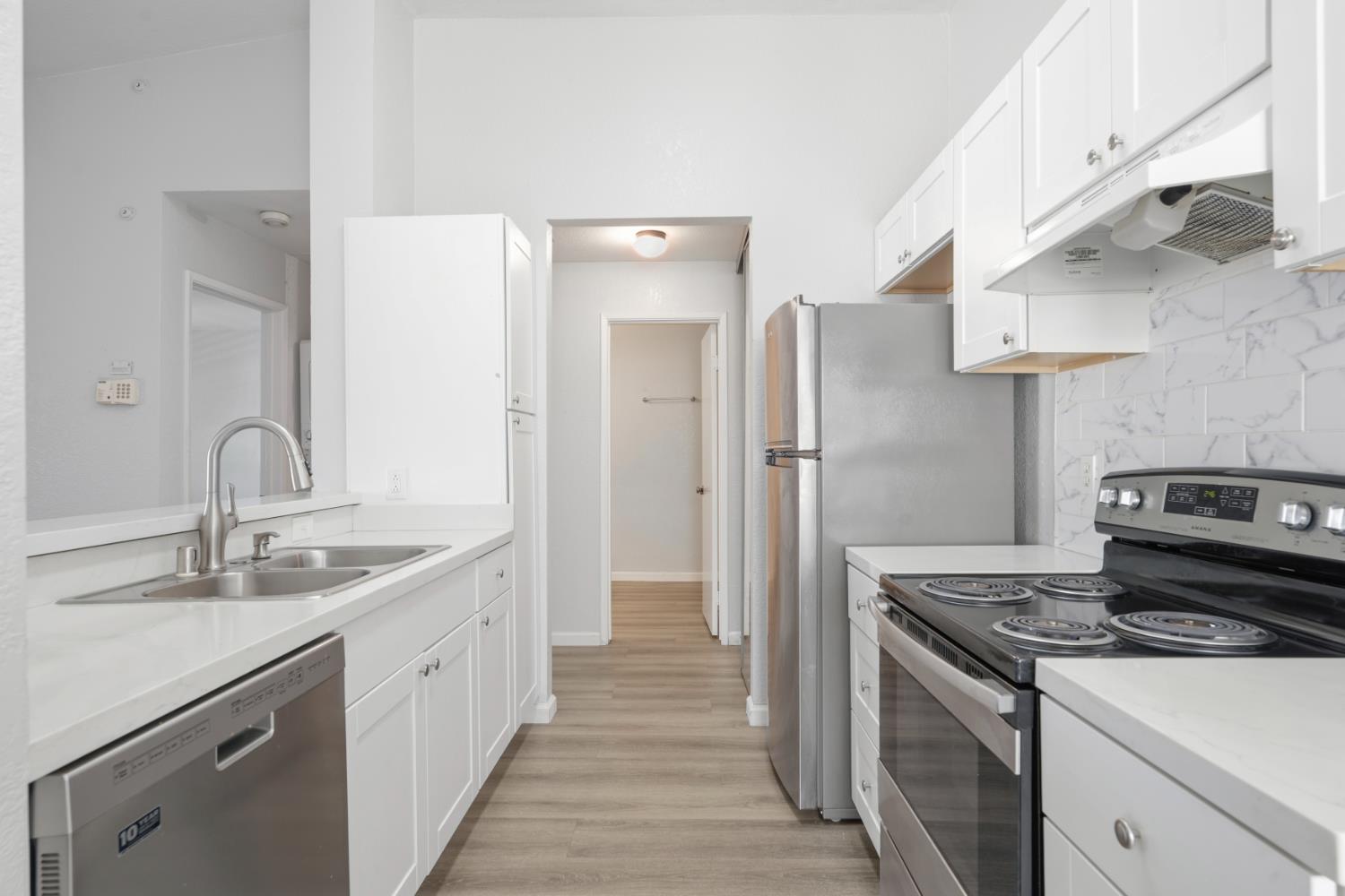3 Lancaster Circle, Unit 209 Bay Point, CA 94565 - Photo 6 of 30 a kitchen with a sink and a refrigerator