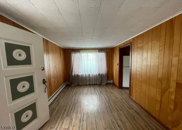 a view of an entryway door with wooden floor
