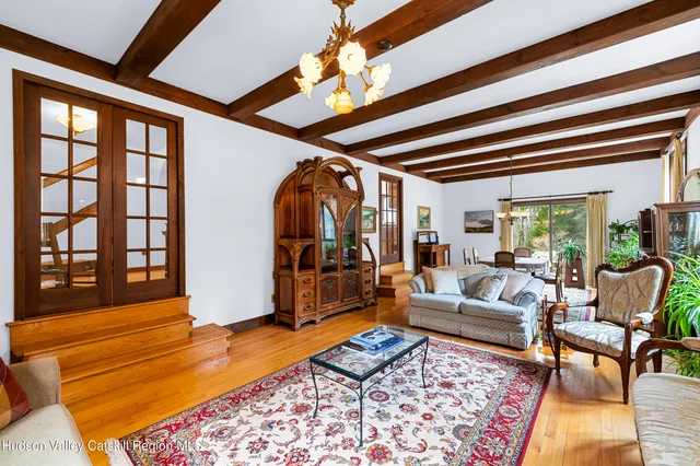 a living room with furniture a rug and a chandelier
