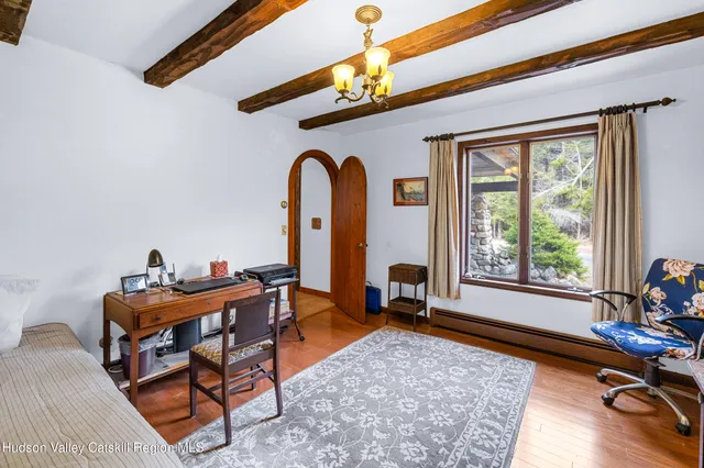 a livingroom with workspace and a window