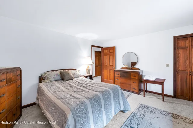 a bedroom with a bed and a desk