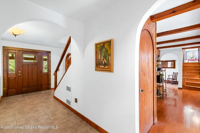 a view of entryway and hall with wooden floor