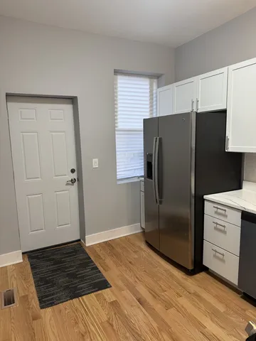 a kitchen with a refrigerator and a stove