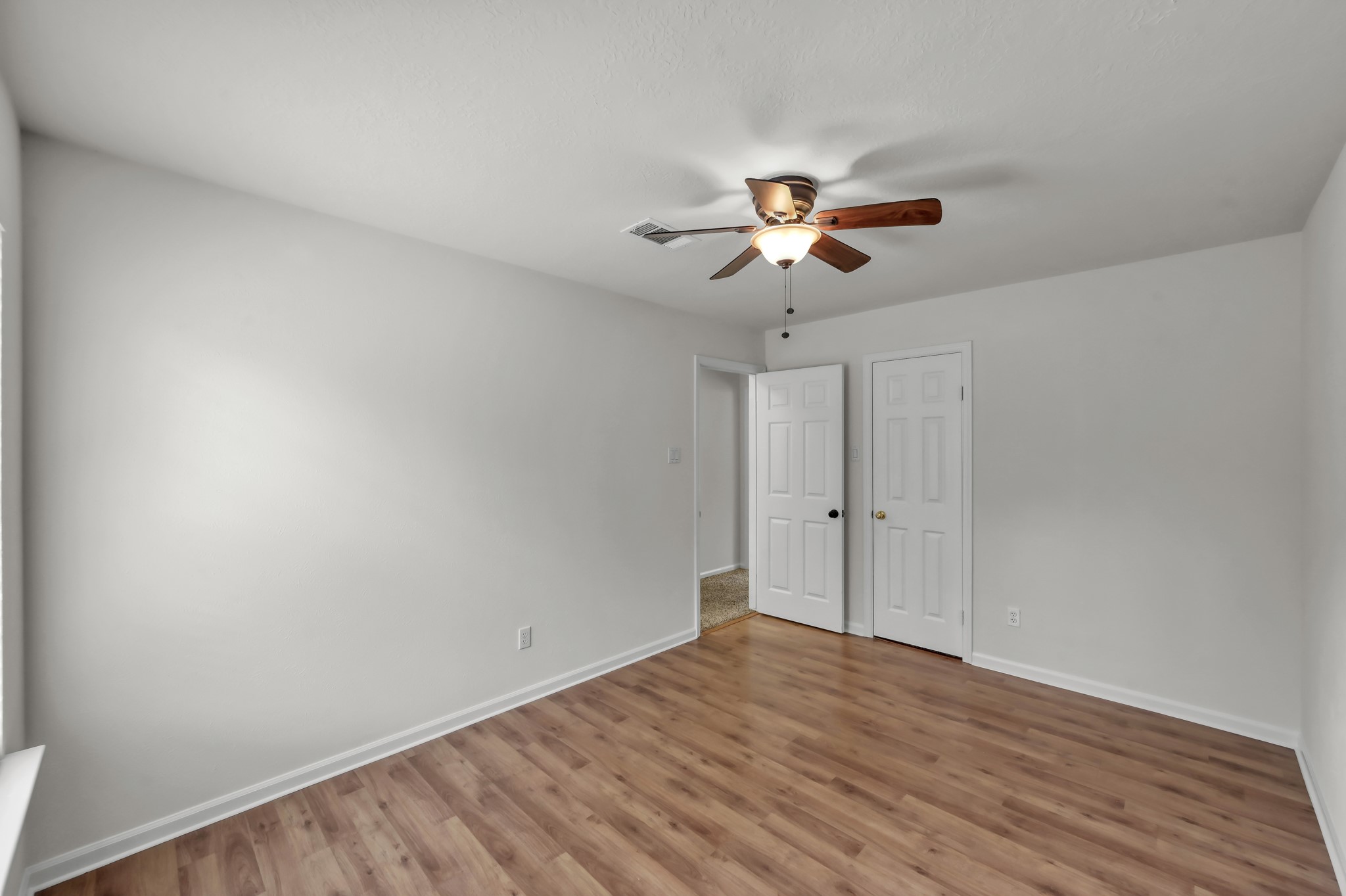 114 Regency Way Conroe, TX 77304 - Photo 35 of 48 Bedroom #4 of 5 with laminate flooring and large walk in closet.