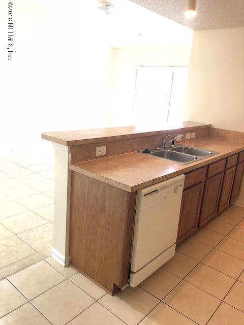 7920 Merrill Road, Unit 1813 Jacksonville, FL 32277 - Photo 3 of 9 a utility room with dryer and washer
