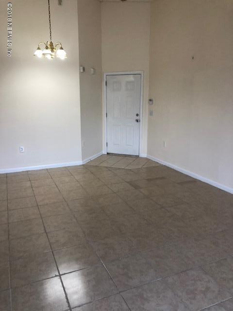 7920 Merrill Road, Unit 1813 Jacksonville, FL 32277 - Photo 4 of 9 a view of a livingroom with a kitchen