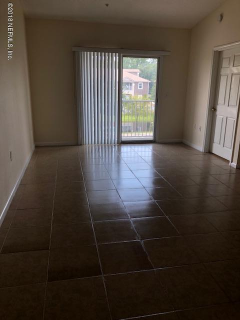 7920 Merrill Road, Unit 1813 Jacksonville, FL 32277 - Photo 5 of 9 a view of an empty room with a window