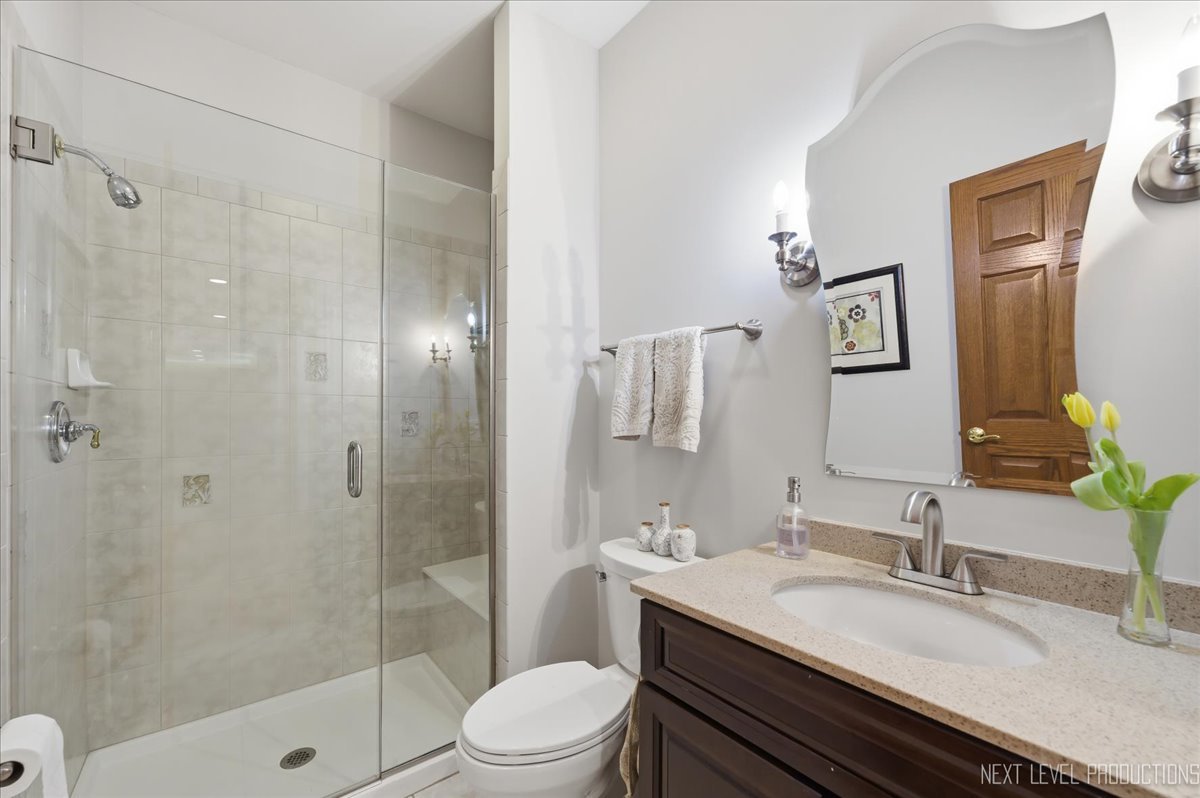 1914 North Ridge Avenue Arlington Heights, IL 60004 - Photo 19 of 50 a bathroom with a granite countertop sink toilet a shower and a mirror