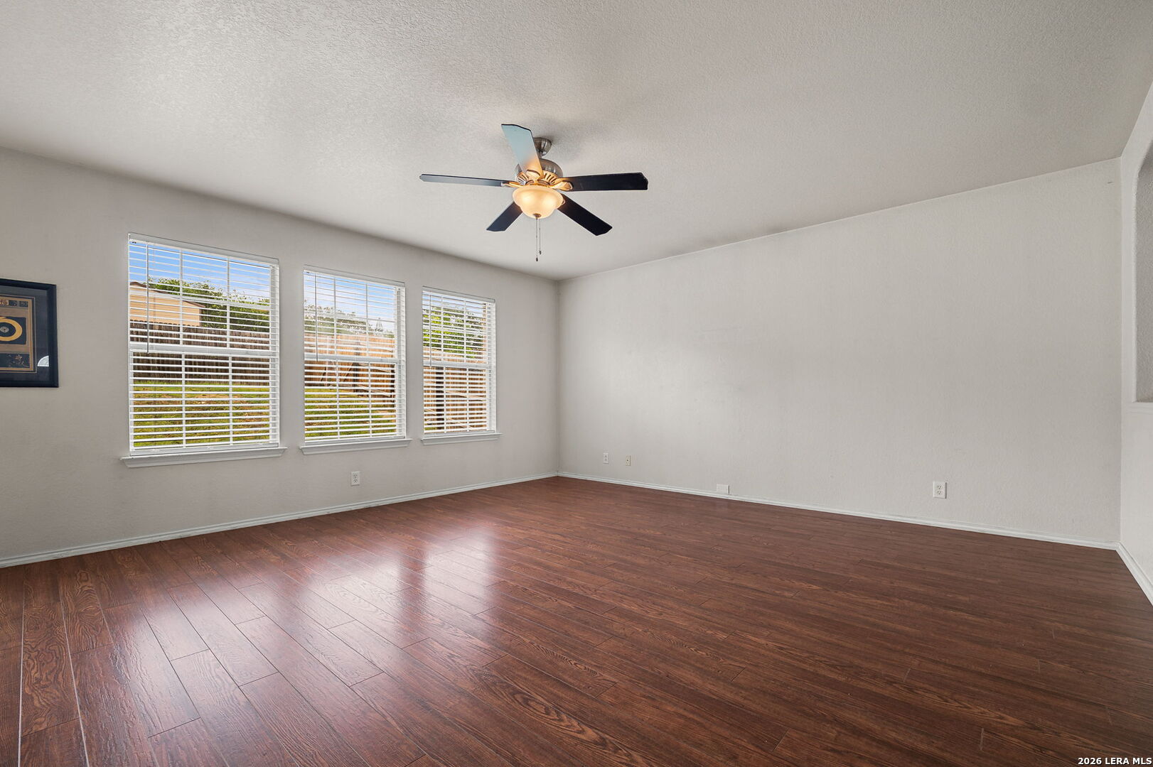7207 Avery Road Live Oak, TX 78233 - Photo 11 of 32 a view of empty room with wooden floor and fan