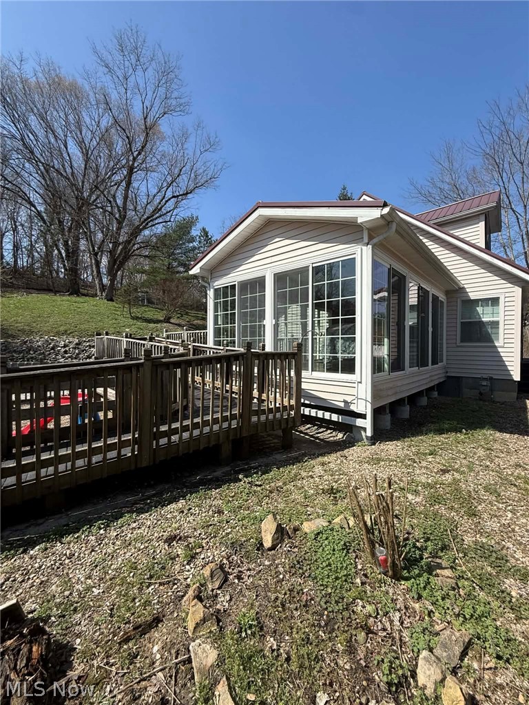7170 Old Town Road Mount Perry, OH 43760 - Photo 28 of 41 Rear view of property featuring a wooden deck, a metal roof, and a yard
