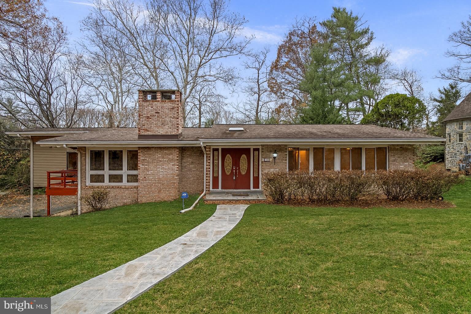 a front view of a house with a yard and porch