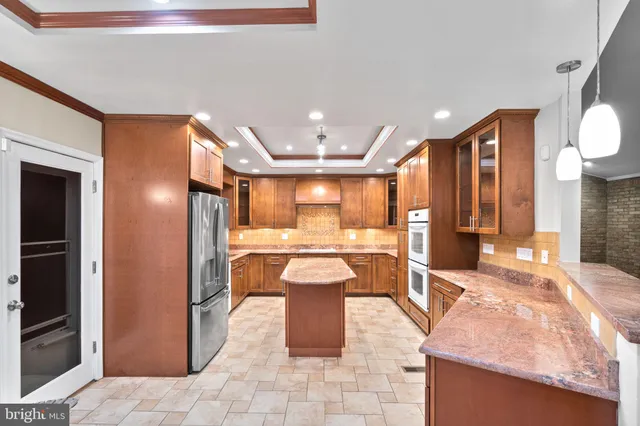 a kitchen with stainless steel appliances granite countertop a sink and stove