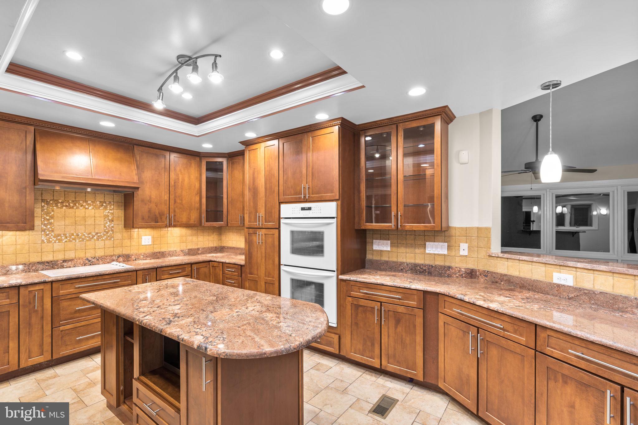 7711 Arrowood Court Bethesda, MD 20817 - Photo 15 of 59 a kitchen with stainless steel appliances granite countertop a sink and stove