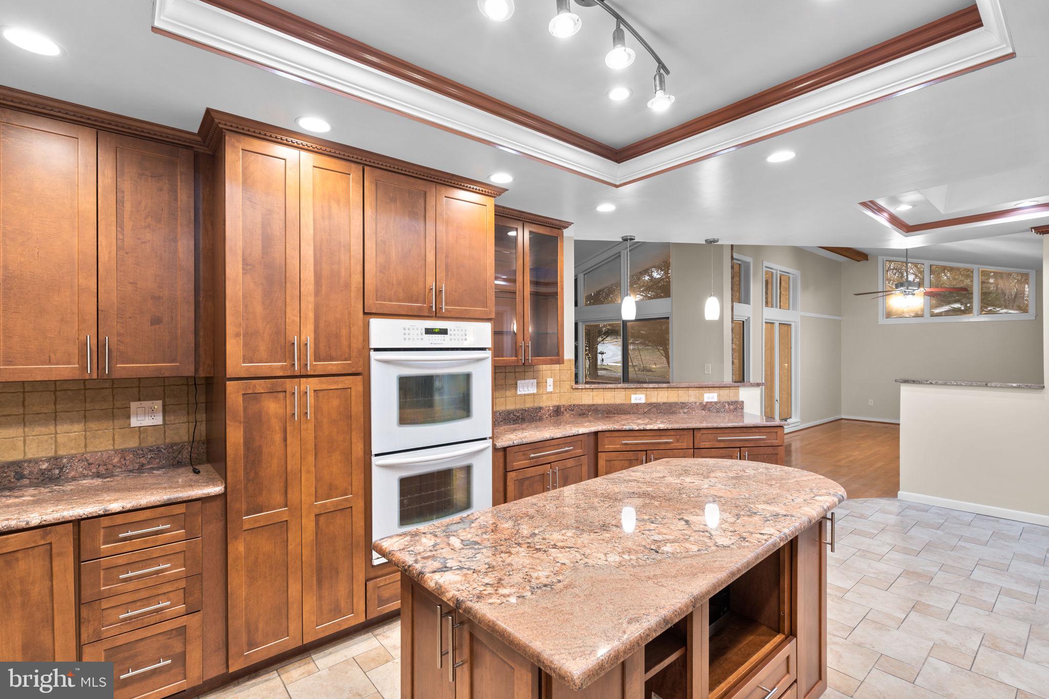 7711 Arrowood Court Bethesda, MD 20817 - Photo 16 of 59 a kitchen with stainless steel appliances granite countertop a sink refrigerator and cabinets