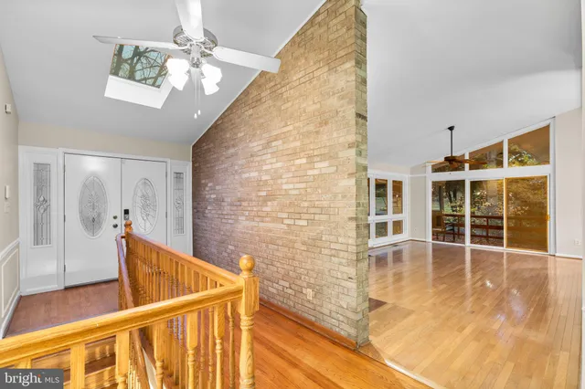 a view of a livingroom with wooden floor and a fireplace