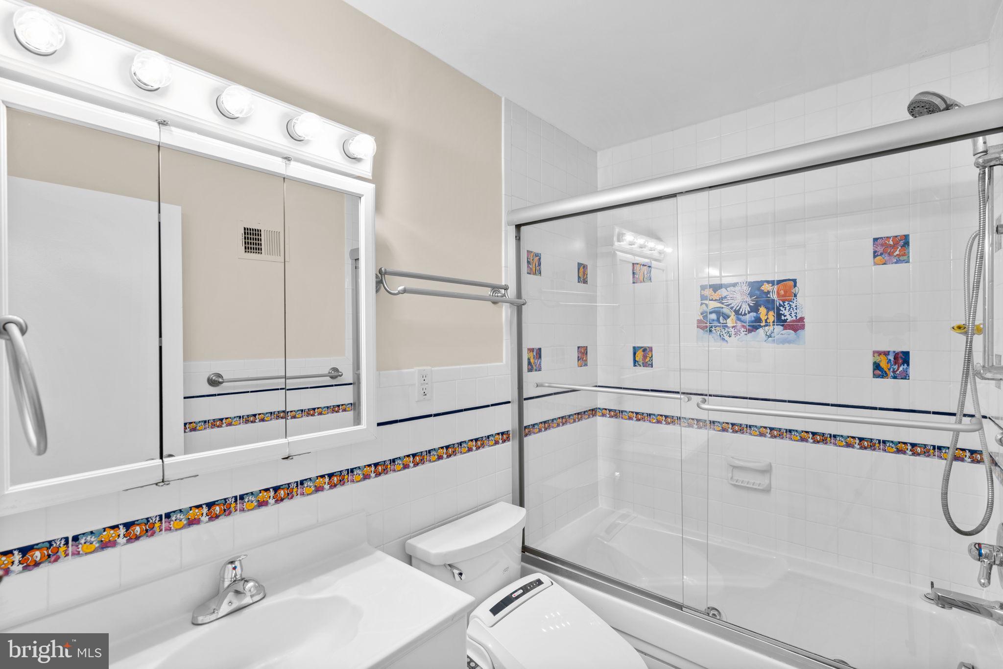 7711 Arrowood Court Bethesda, MD 20817 - Photo 32 of 59 a bathroom with a bathtub and a shower