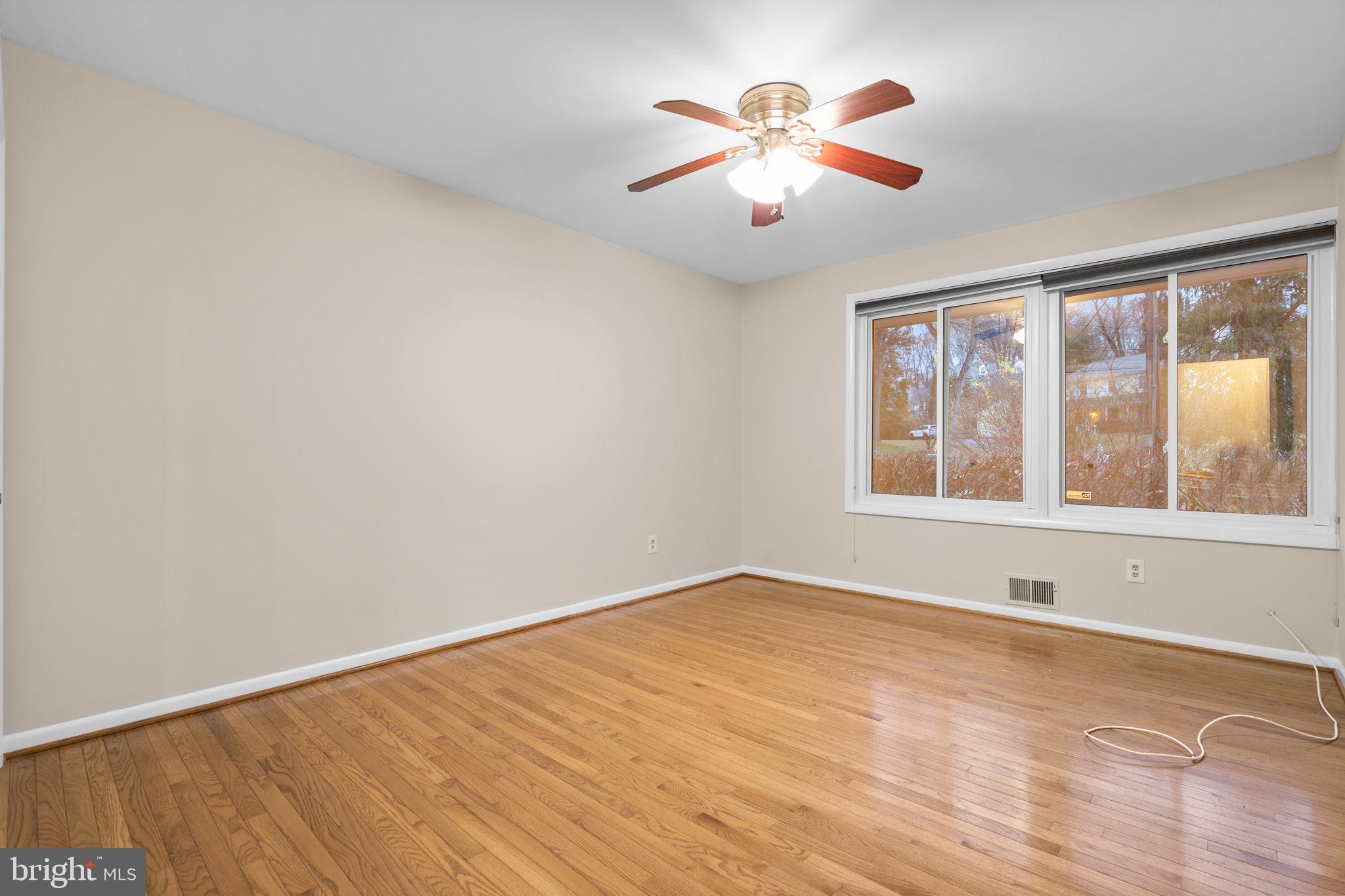 7711 Arrowood Court Bethesda, MD 20817 - Photo 34 of 59 wooden floor in an empty room with a window