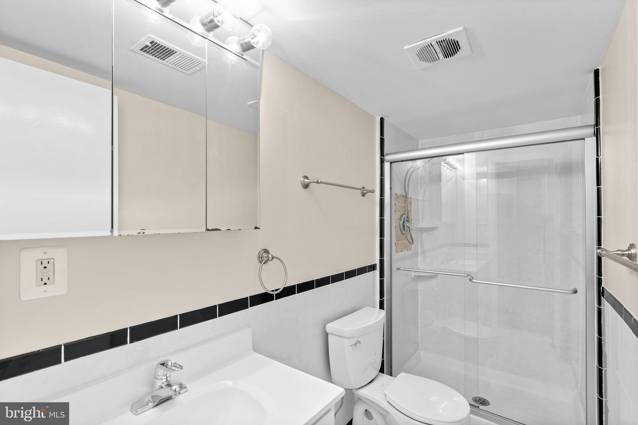 7711 Arrowood Court Bethesda, MD 20817 - Photo 36 of 59 a bathroom with a sink and a mirror