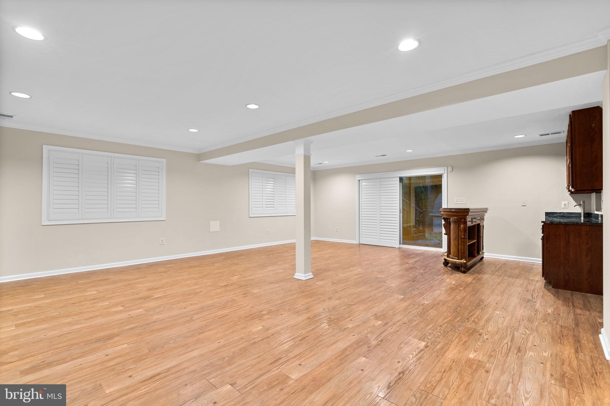 7711 Arrowood Court Bethesda, MD 20817 - Photo 37 of 59 a view of empty room with wooden floor and fireplace