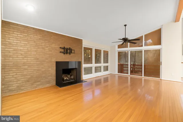 a view of an empty room with a fireplace and a window