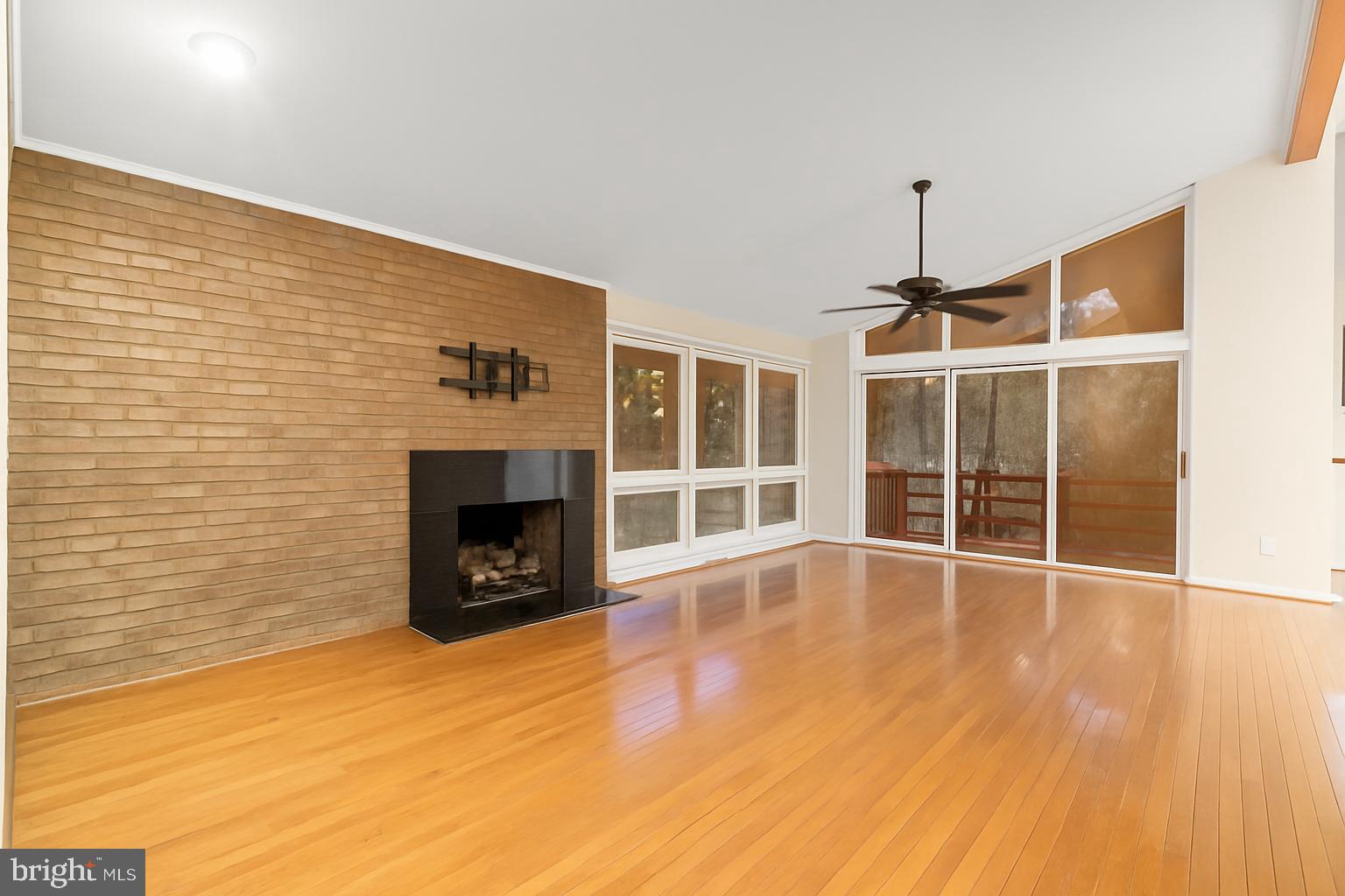 7711 Arrowood Court Bethesda, MD 20817 - Photo 4 of 59 a view of a livingroom with wooden floor and a fireplace