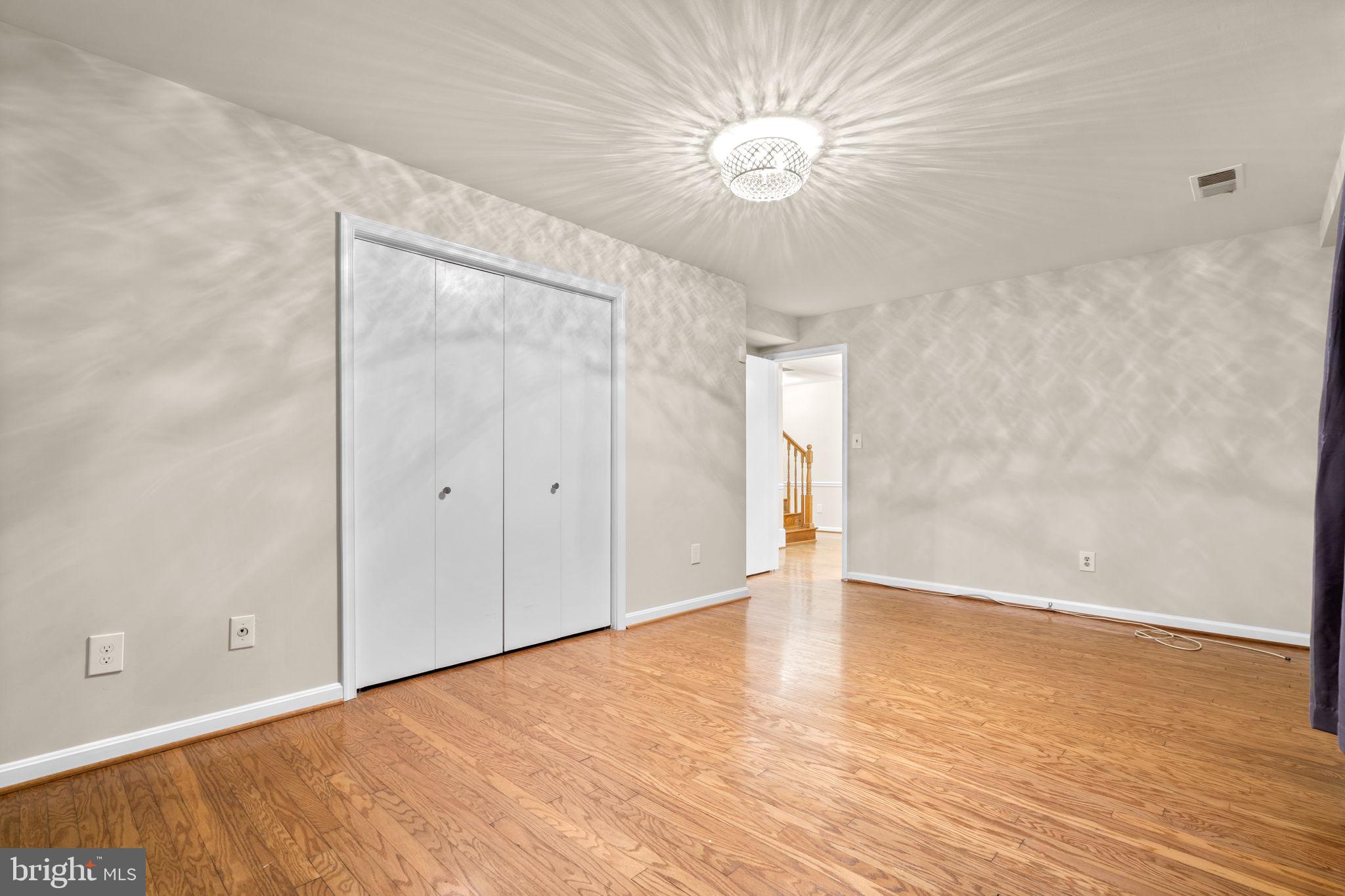 7711 Arrowood Court Bethesda, MD 20817 - Photo 42 of 59 a view of an empty room with wooden floor