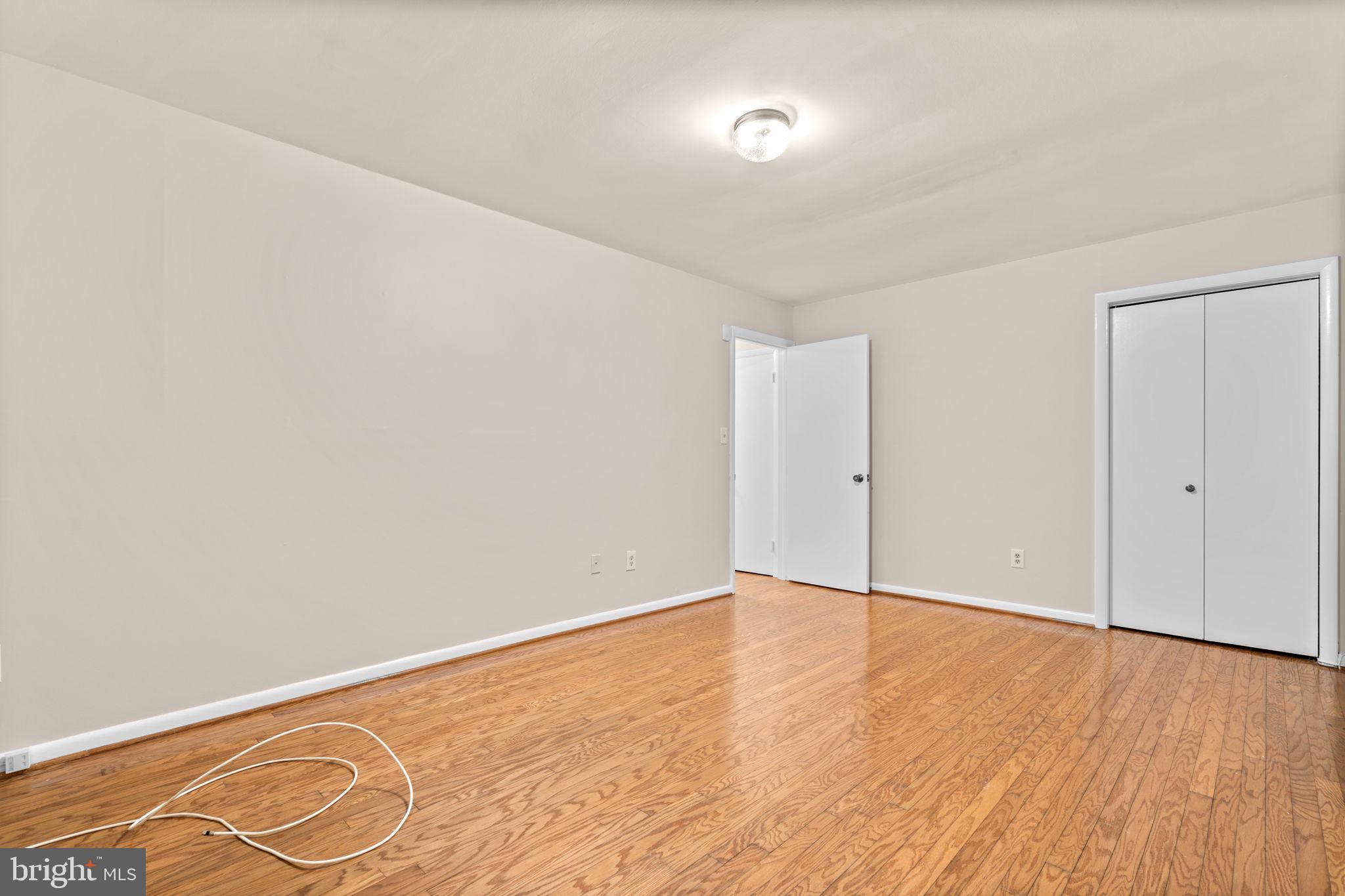 7711 Arrowood Court Bethesda, MD 20817 - Photo 44 of 59 an empty room with wooden floor