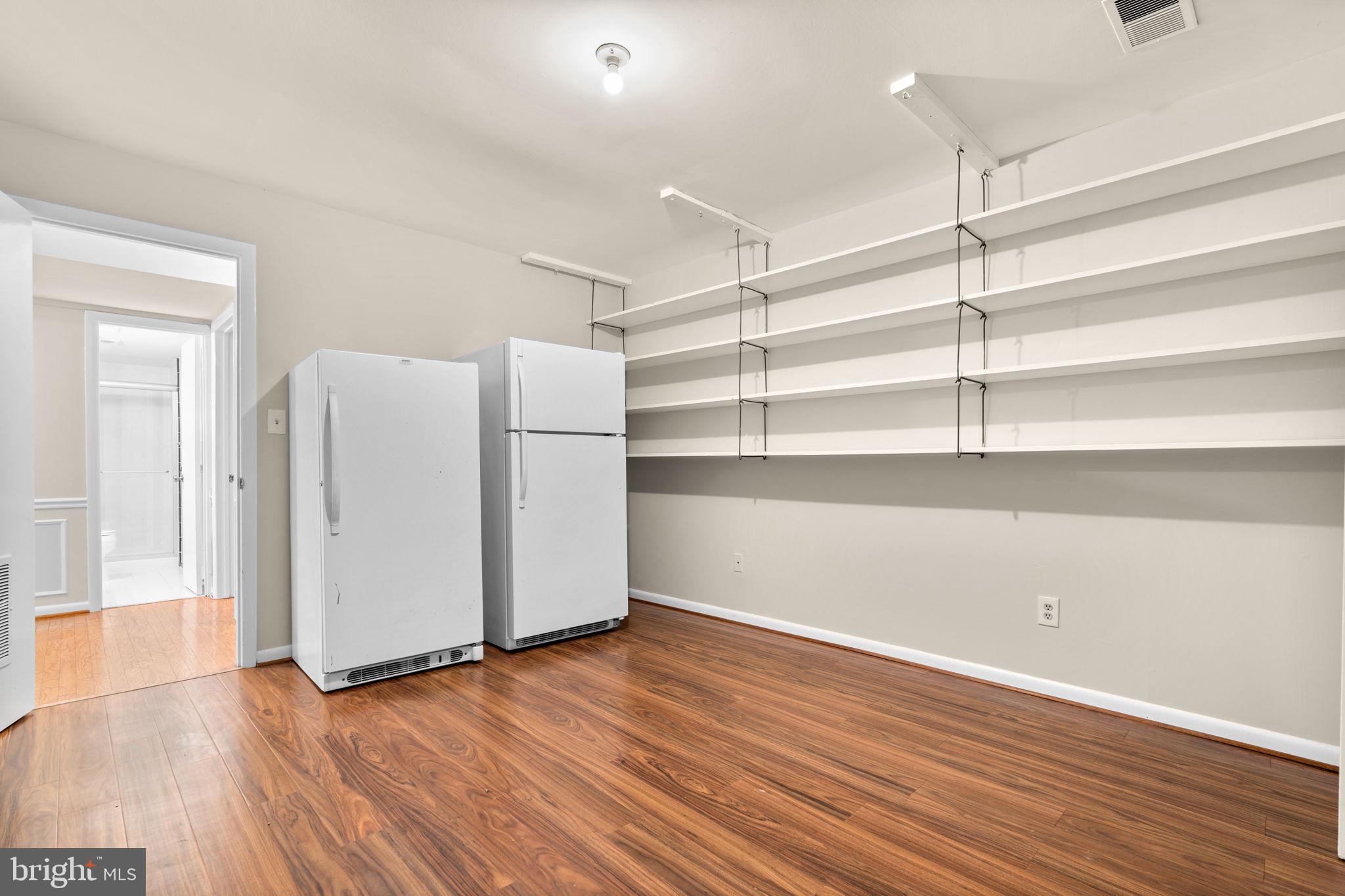 7711 Arrowood Court Bethesda, MD 20817 - Photo 47 of 59 a view of an empty room with wooden floor and a window