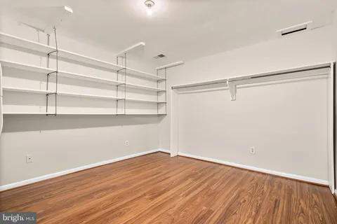 a view of a white house with a big yard and large trees