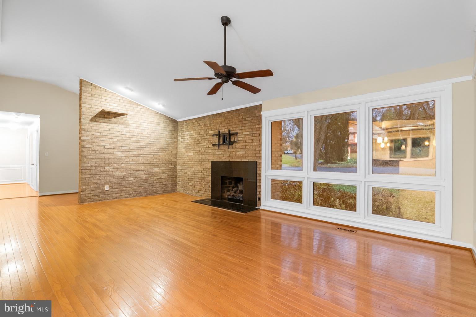 7711 Arrowood Court Bethesda, MD 20817 - Photo 5 of 59 a view of an empty room with a fireplace and a window