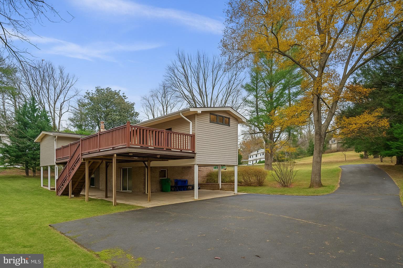 7711 Arrowood Court Bethesda, MD 20817 - Photo 55 of 59 a view of a white house with a big yard and large trees