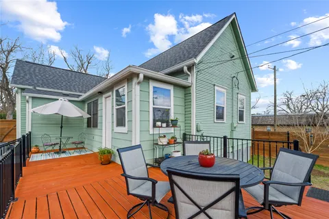 a view of a balcony with chairs and wooden floor