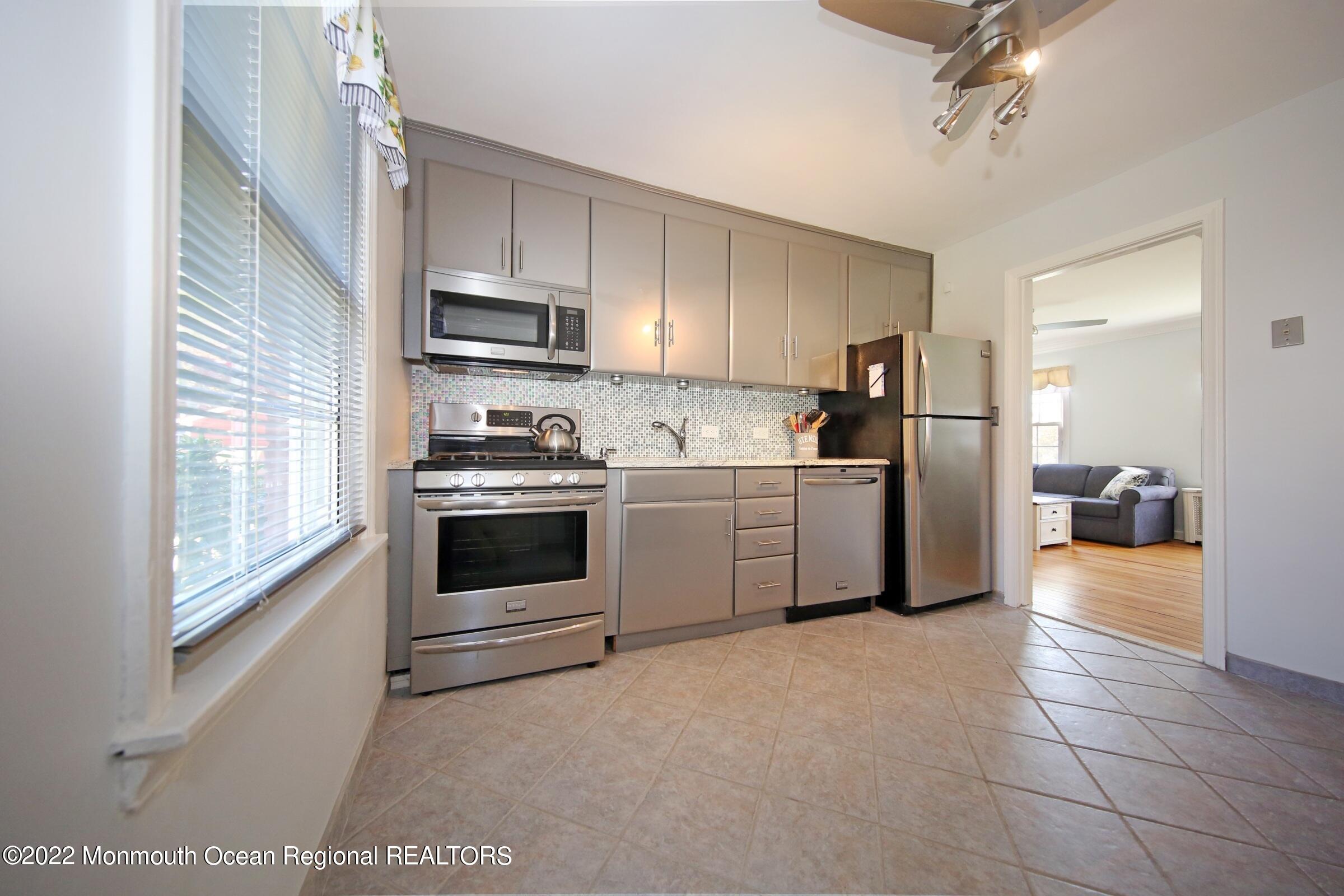40 Pinckney Road, Unit 40B Red Bank, NJ 07701 - Photo 12 of 23 a kitchen with a stove a sink and a refrigerator