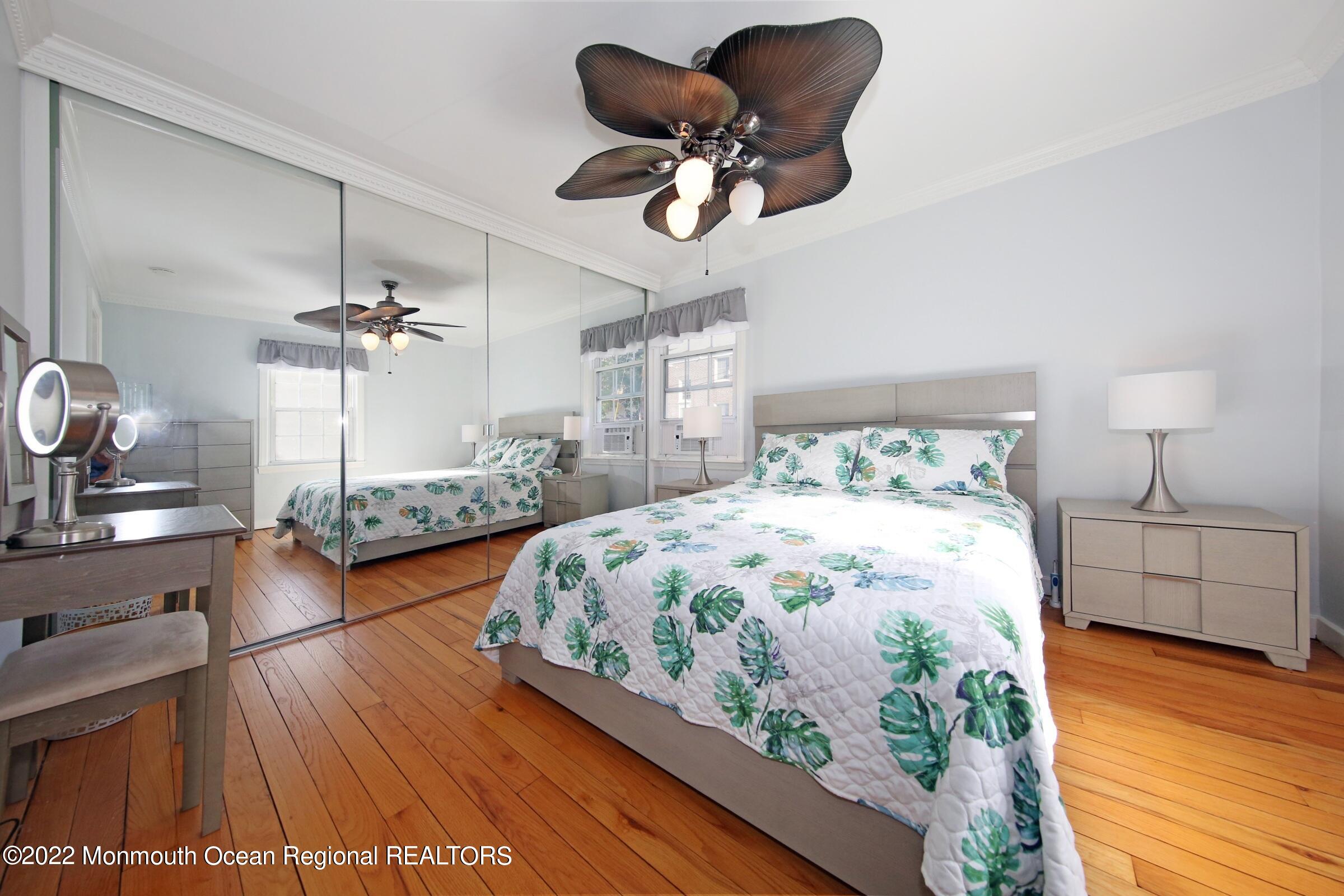 40 Pinckney Road, Unit 40B Red Bank, NJ 07701 - Photo 18 of 23 a bedroom with furniture and a wooden floor