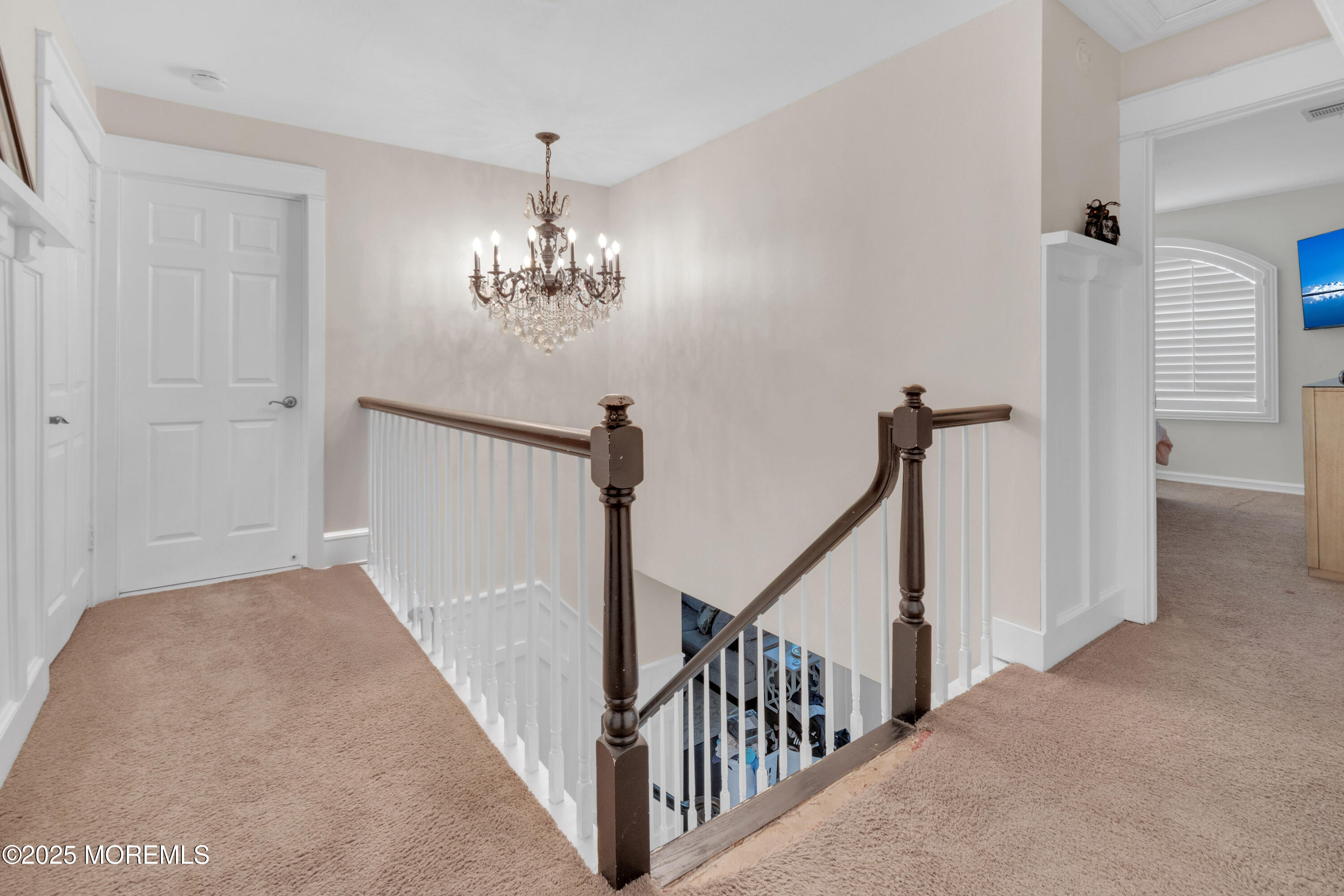 41 Longstreet Road Manalapan, NJ 07726 - Photo 15 of 51 a view of a hallway with a chandelier