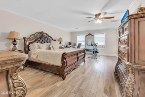 a bedroom with a bed and wooden floor