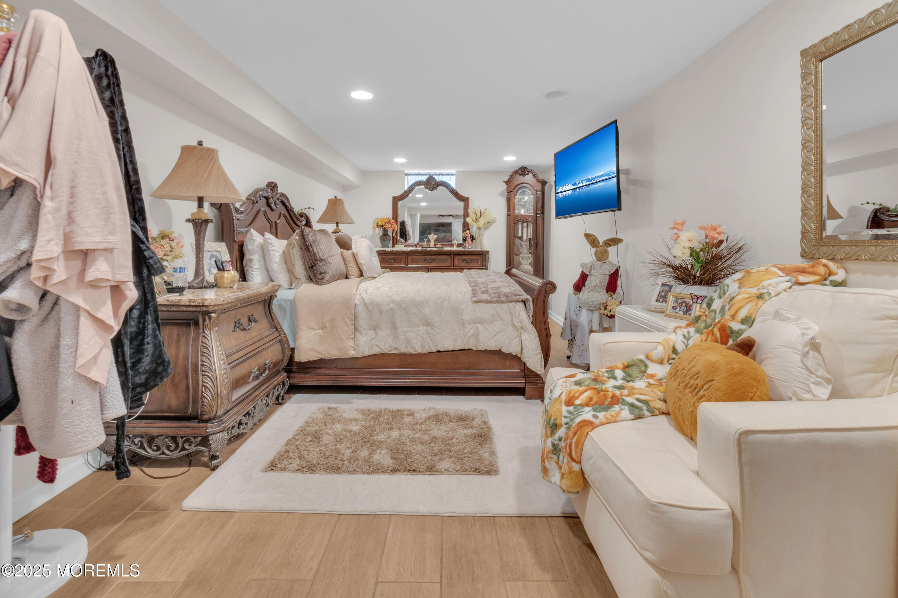 41 Longstreet Road Manalapan, NJ 07726 - Photo 19 of 51 a living room with furniture and a flat screen tv