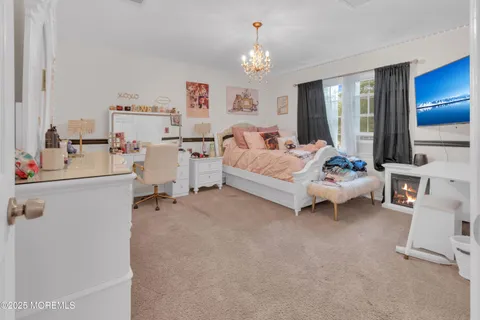 a bed room with furniture and a chandelier